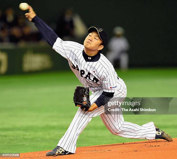 Starting pitcher Takahiro Norimoto of Samurai Japan delivers a pitch during the game three of Samurai Japan and MLB All Stars at Tokyo Dome on...