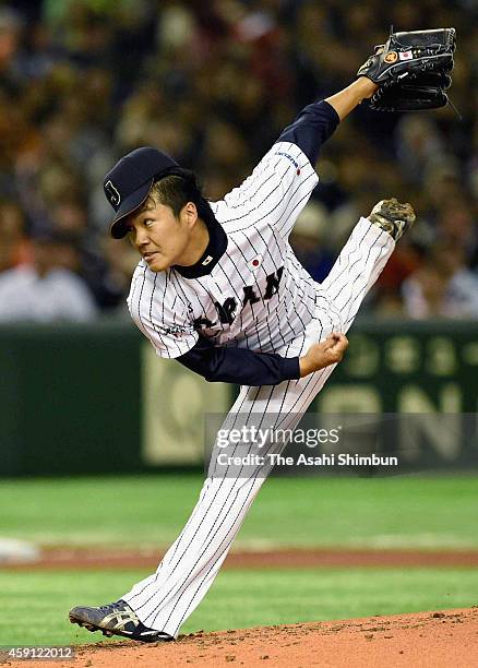 Starting pitcher Takahiro Norimoto of Samurai Japan delivers a pitch during the game three of Samurai Japan and MLB All Stars at Tokyo Dome on...