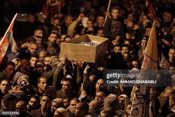 Palestinian mourners attend the funeral of bus driver Yusuf Hasan al-Ramuni in the West Bank town of Abu Dis from Jerusalem on November 17, 2014. A...