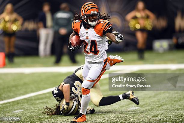 Adam Jones of the Cincinnati Bengals avoids a tackle by Marcus Ball of the New Orleans Saints during a game at the Mercedes-Benz Superdome on...