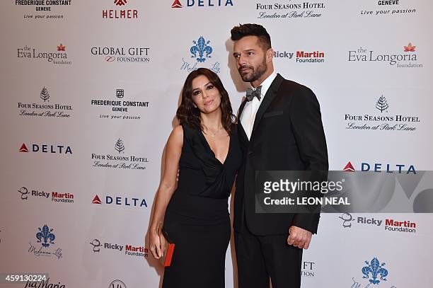 Actress Eva Longoria and Puerto Rican pop musician Ricky Martin pose as they arrive at the 5th annual London Global Gift Gala in London on November...