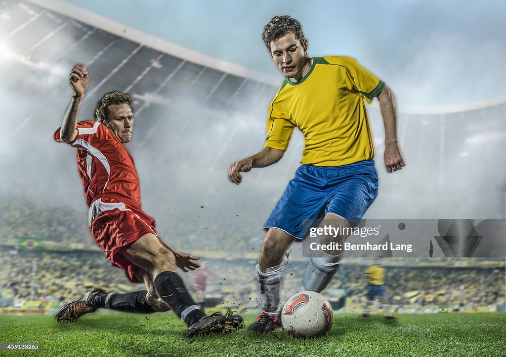 Two soccer players fighting for ball in stadium