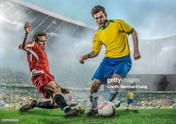 two soccer players fighting for ball in stadium - two guys playing soccer stockfoto's en -beelden