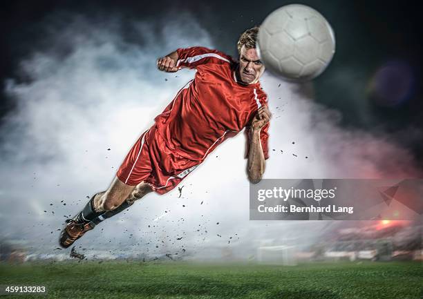 soccer player heading ball in stadium - ヘディングをする ストックフォトと画像