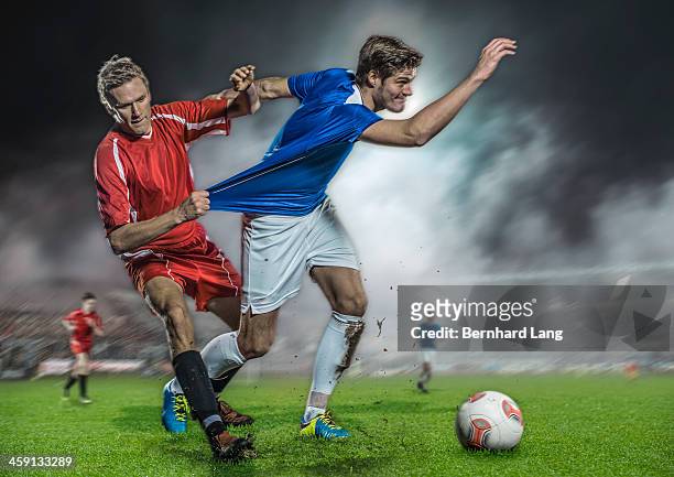 soccer player pulling jersey of his opponent - strip stock-fotos und bilder