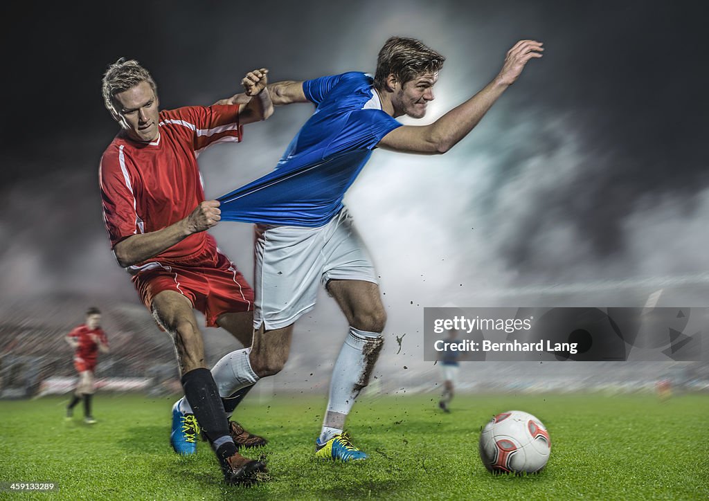 Soccer player pulling jersey of his opponent