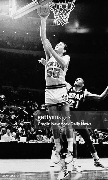 Kiki Vandeweghe of the New York Knicks scores past Kevin Edwards of the Miami Heat.