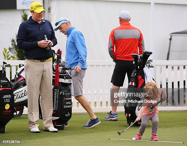 Jarrod Lyle of Australia watches daughter Lucy Lyle putt on the practice green ahead of the 2014 Australian Masters at The Metropolitan Golf Course...