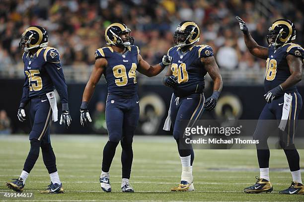 McDonald, Robert Quinn, Michael Brockers and Kendall Langford all of the St. Louis Rams celebrates a sack during a game against the New Orleans...