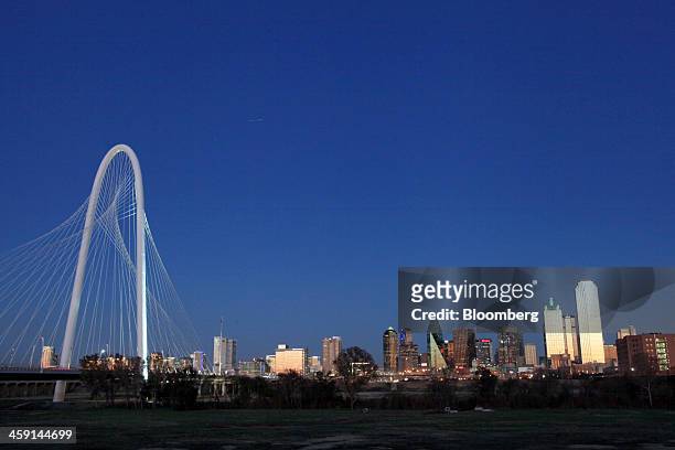 The Margaret Hunt Hill Bridge stands in front of the Dallas skyline in Dallas, Texas, U.S., on Tuesday, Dec. 17, 2013. The U.S. Economy expanded in...