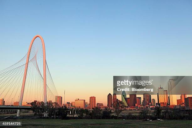 The Margaret Hunt Hill Bridge stands in front of the Dallas skyline at sunset in Dallas, Texas, U.S., on Tuesday, Dec. 17, 2013. The U.S. Economy...