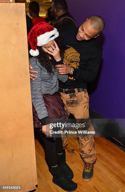 Deyjah Harris and T.I. Attend a toy drive at Metroplex Atlanta on December 20, 2013 in Atlanta, Georgia.