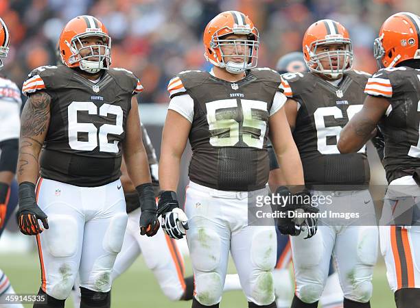 Offensive linemen Jason Pinkston, Alex Mack, and Shawn Lauvao of the Cleveland Browns looks at the scoreboard in-between plays during a game against...
