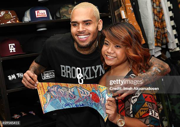 Singer Chris Brown greets fans at the 1st Annual Xmas Toy Drive hosted by himself and Brooklyn Projects on December 22, 2013 in Los Angeles,...