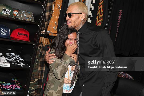 Singer Chris Brown greets fans at the 1st Annual Xmas Toy Drive hosted by himself and Brooklyn Projects on December 22, 2013 in Los Angeles,...