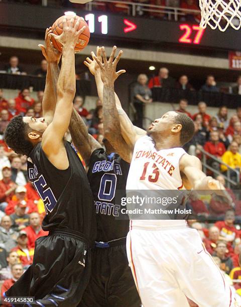 Guard Bryce Dejean-Jones of the Iowa State Cyclones battles for a rebound with guards Jalen Brown and Kevin Ware of the Georgia State Panthers, in...