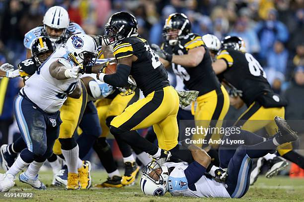 George Wilson of the Tennessee Titans is stepped on as he attempts to tackle Le'Veon Bell of the Pittsburgh Steelers in the second quarter at LP...