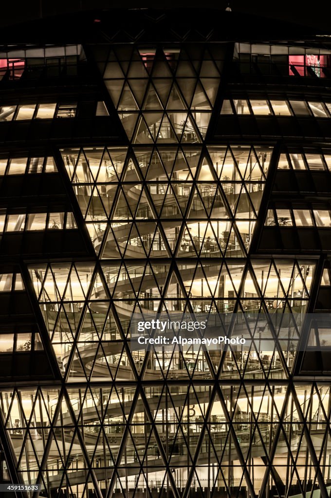 Office building at night with people working - V