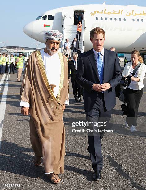 Prince Harry speaks with the Sultan of Oman's First Cousin His Highness Sayyid Haithem Bin Tariq Al Said as he arrives at the VIP section of Muscat...