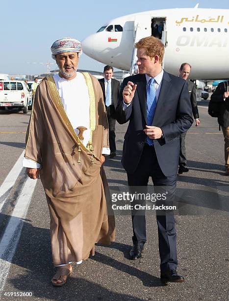 Prince Harry speaks with the Sultan of Oman's First Cousin His Highness Sayyid Haithem Bin Tariq Al Said as he arrives at the VIP section of Muscat...
