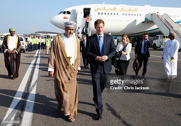 Prince Harry chats to the Sultan of Oman's First Cousin His Highness Sayyid Haithem Bin Tariq Al Said as he arrives at the VIP section of Muscat...
