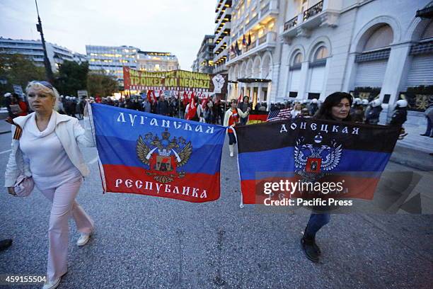 Protesters carry the flag of the Lugansk People's Republic and the flag of the Donetsk People's Republic . Both are pro-Russian self-proclaimed...