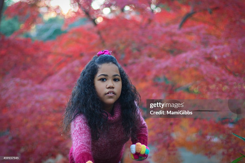 Girl and red maple leaf