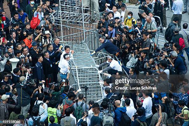 Bailiffs and Citic tower employees clear a barricade set up by pro-democracy Occupy Central protesters on Lung Wui Road in font of Citic tower, on...