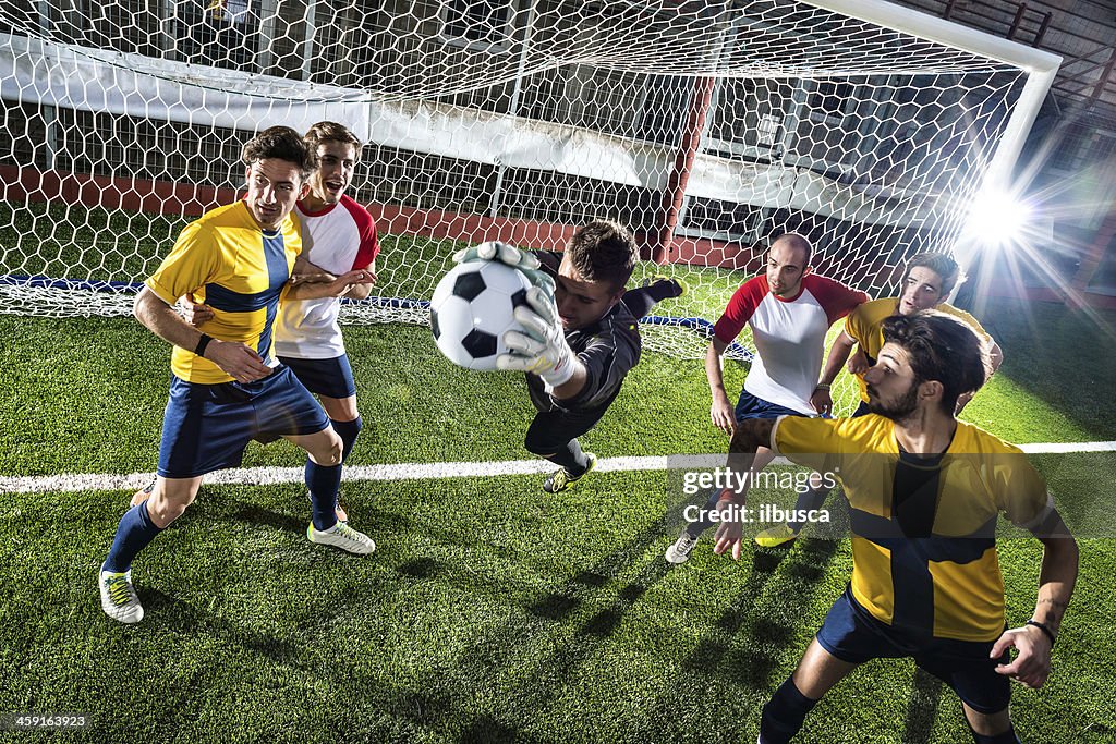 Football match in stadium: Goalkeeper save
