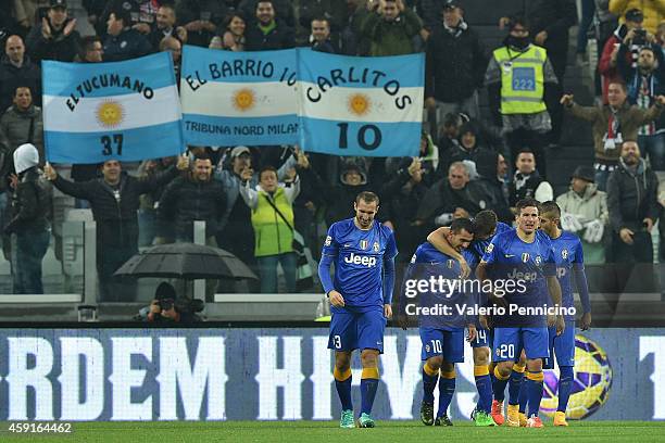 Carlos Tevez of Juventus FC celebrates a goal with team-mates during the Serie A match between Juventus FC and Parma FC at Juventus Arena on November...