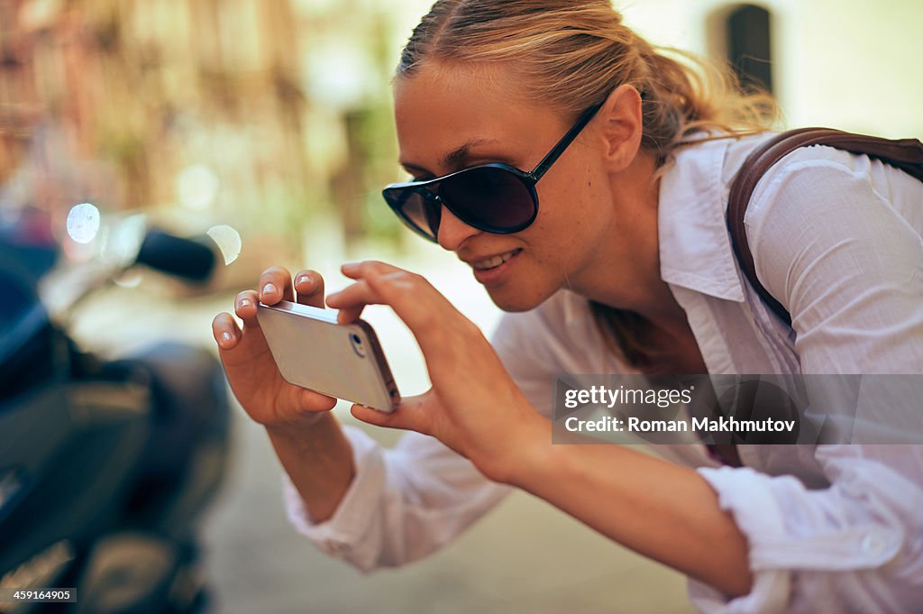 Girl photographing with mobile device