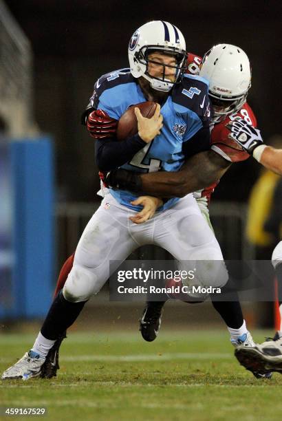 Quarterback Ryan Fitzpatrick of the Tennessee Titans scrambles as linebacker Daryl Washington tackles him during a NFL game at LP Field on December...