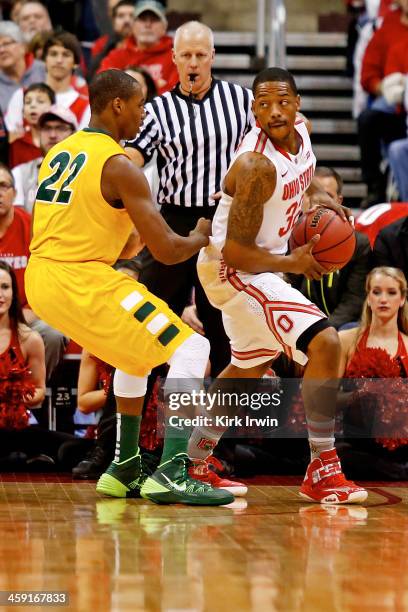 Lenzelle Smith, Jr. #32 of the Ohio State Buckeyes is defended by Kory Brown of the North Dakota State Bison during the first half at Value City...