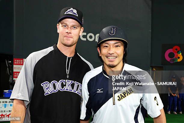 Justin Morneau of the Colorado Rockies and Nobuhiro Matsuda of Samurai Japan pose for photographs prior to the game five of Samurai Japan and MLB All...