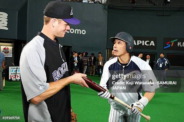 Justin Morneau of the Colorado Rockies and Nobuhiro Matsuda of Samurai Japan talk prior to the game five of Samurai Japan and MLB All Stars at...