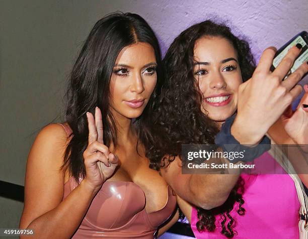 Kim Kardashian poses for a selfie with a fan as she arrives to promote her new fragrance "Fleur Fatale" at a Spice Market event on November 18, 2014...