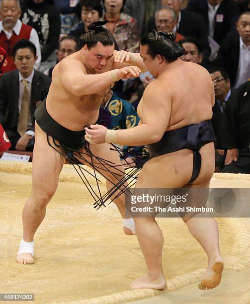 Mongolian yokozuna Harumafuji pushes ozeki Kisenosato out of the ring to win during day ten of the Grand Sumo Kyushu Tournament at Fukuoka Convention...