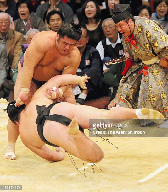Tochiozan throws Ikioi to win during day ten of the Grand Sumo Kyushu Tournament at Fukuoka Convention Center on November 18, 2014 in Fukuoka, Japan.
