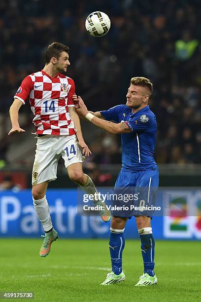 Marcelo Brozovic of Croatia is challenged by Ciro Immobile of Italy during the EURO 2016 Group H Qualifier match between Italy and Croatia at Stadio...