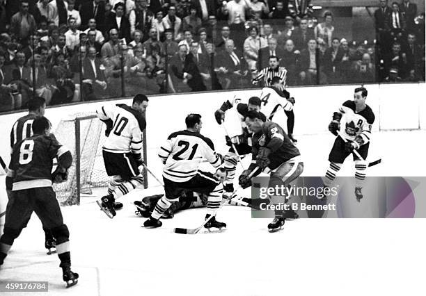Gordie Howe of the Detroit Red Wings tries to score as he is defended by goalie Johnny Bower, George Armstrong, Bob Baun and Allan Stanley of the...