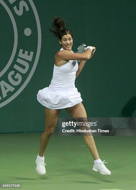 Punjab Marshalls player Garbine Muguruza plays a shot against Delhi Dreams players Jelena Jankovic and Kevin Anderson during mixed doubles at...