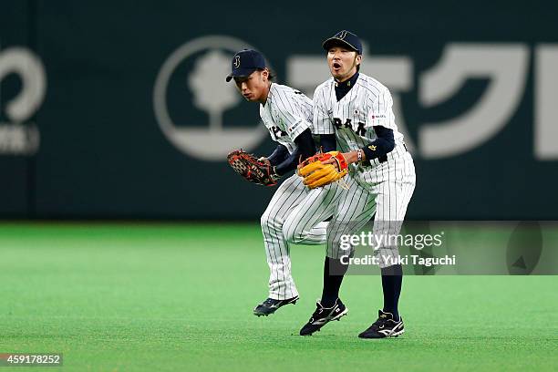 Kenta Imamiya and Ryosuke Kikuchi of the Samurai Japan collide while trying to field a Yasiel Puig of the Los Angeles Dodgers ground ball in the...