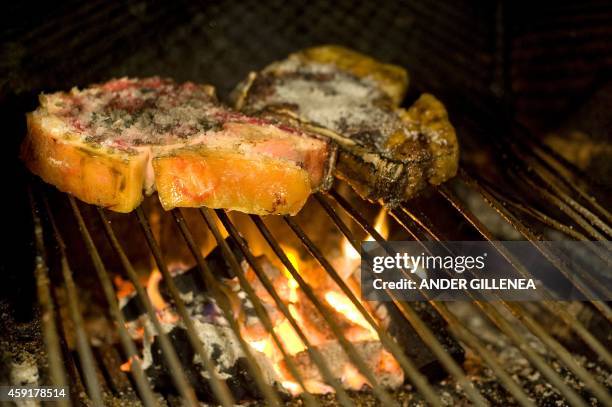 Picture taken on November 18, 2014 shows "Txuleta" meat on a grill at the Casa Julian restaurant in the northern Spanish Basque city of Tolosa on...