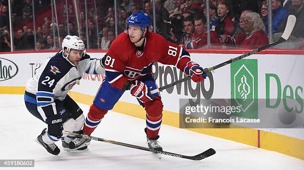 Lars Eller of the Montreal Canadiens and Grant Clitsome of the Winnipeg Jets skate in the NHL game at the Bell Centre on November 11, 2014 in...