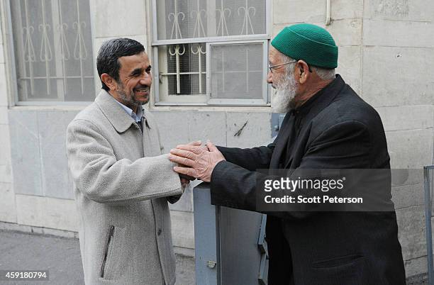 Former Iranian President Mahmoud Ahmadinejad speaks to supporters and receives letters requesting help outside his home at "Square 72" in the...
