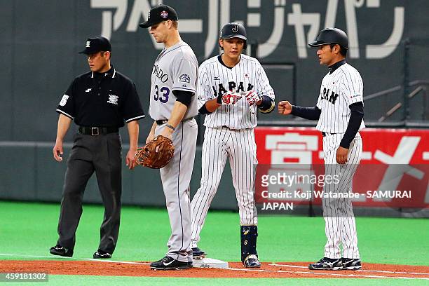 Hayato Sakamoto of Samurai Japan hits a single in the first inning during the game five of Samurai Japan and MLB All Stars at Sapporo Dome on...