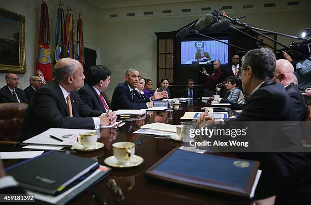 President Barack Obama speaks as Secretary of Homeland Security Jeh Johnson, White House Ebola Czar Ron Klain, White House Homeland Security Adviser...