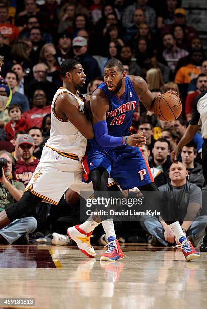 Greg Monroe of the Detroit Pistons controls the ball against Tristan Thompson of the Cleveland Cavaliers at The Quicken Loans Arena on December 23,...