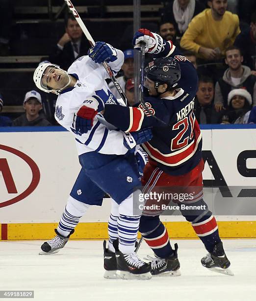 Nazem Kadri of the Toronto Maple Leafs and Chris Kreider of the New York Rangers collide during the second period at Madison Square Garden on...