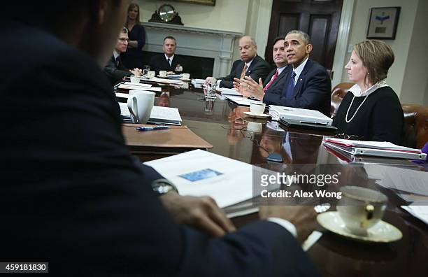 President Barack Obama speaks as Secretary of Homeland Security Jeh Johnson, White House Ebola Czar Ron Klain, White House Homeland Security Adviser...
